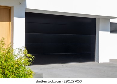 New Black Garage Door (sectional Door) On A Residential House