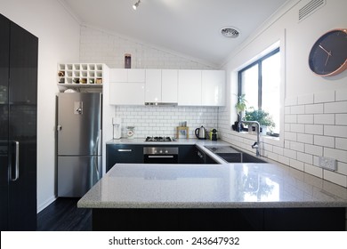 New black and white contemporary kitchen with subway tiles splashback