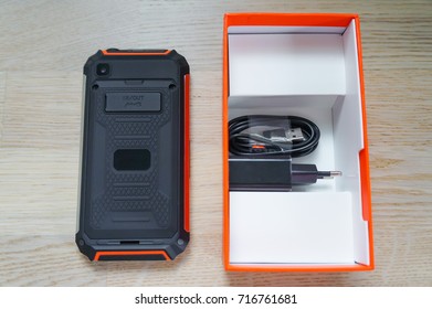 New Black-orange Rugged Smartphone With Box, Charger And Cable - Rear View