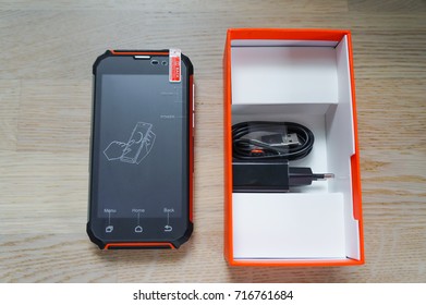 New Black-orange Rugged Smartphone With Box, Charger And Cable - Front View