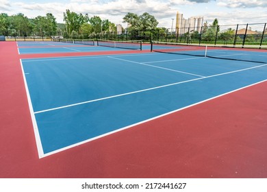 New blue tennis courts with white lines and red out of play area.	 - Powered by Shutterstock