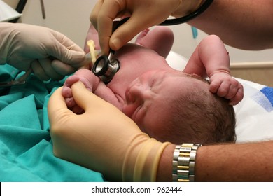 New Born Baby Being Examined By Doctor
