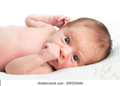 New Born Baby With Blue Eyes On White Background And Pillow