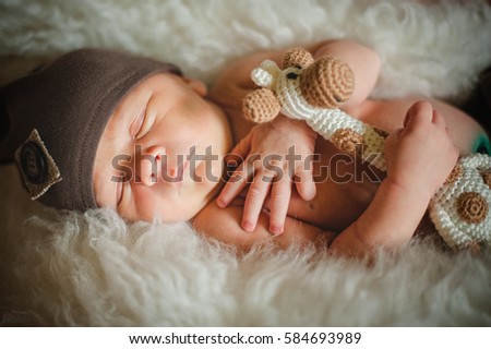 Similar – Newborn baby girl sleeping lying on bed next to mother’s hand