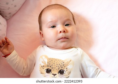 New Born Baby Girl On Texture Blanket, Lying In Bed Opened Eyes.