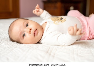 New Born Baby Girl On Texture Blanket, Lying In Bed Opened Eyes.