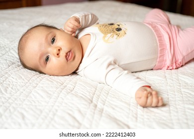 New Born Baby Girl On Texture Blanket, Lying In Bed Opened Eyes.