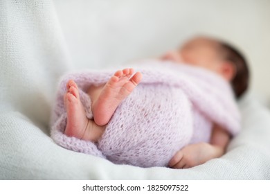 New Born Baby Girl Sleeps At Home, Legs Close Up. Cute Little Kid's Portrait