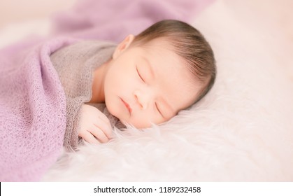 New Born Baby Lying On A Soft Blanket. Cute  New Born Baby In Natural Motion.