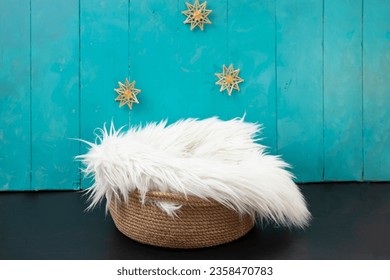 New born or baby portrait photography backdrop with white fur, straw snowflakes, jute rope basket and blue painted wood boards - Powered by Shutterstock
