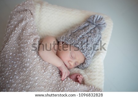 Baby girl with pompom hat sleeping