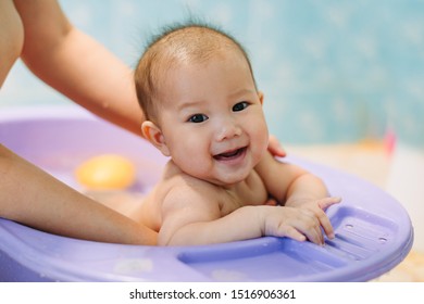 New Born Baby Taking A Bath With Mother. Portrait Of Happy Kids And  Family In Activity Daily Living.