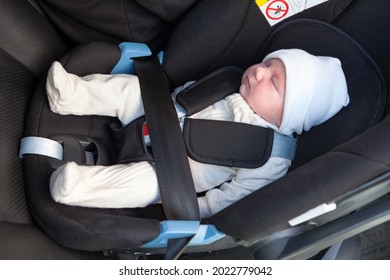 New Born Caucasian Baby Sleeping Inside Of Black Car Safety Seat, Close Up View