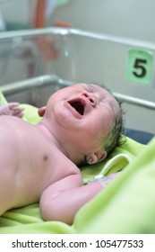 New Born Infant From Cesarean Section In Operating Theater.