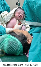 New Born Infant From Cesarean Section In Operating Theater.