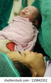 New Born Infant From Cesarean Section In Operating Theater.