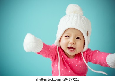 New born in pink warm clothes on the blue background in winter season, Baby healthy and family concept - Powered by Shutterstock