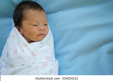 baby in swaddling clothes