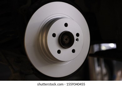 new brake disc on a car in a car service - Shutterstock ID 1559340455