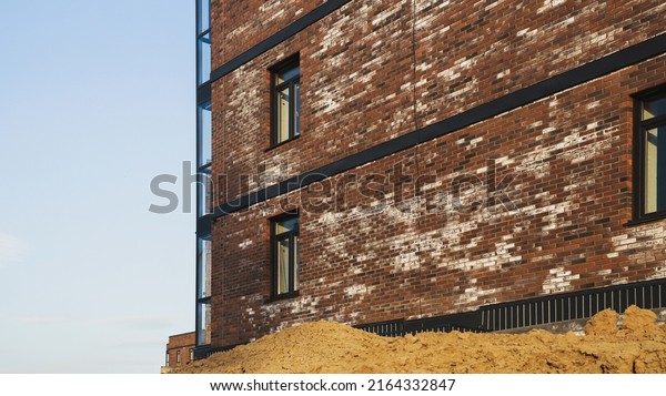 A new brick house stained with white\
efflorescence, a crystalline of salt, formed due to water being\
present in the bricks. Construction\
defects