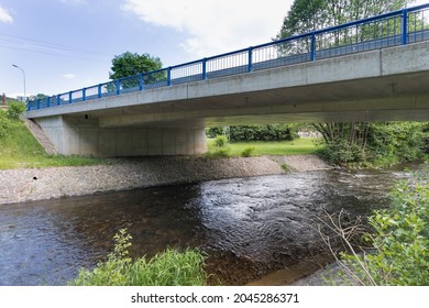 A new bridge across a small river. Summer time. 
Small reinforced concrete bridge after reconstruction. New asphalt. - Powered by Shutterstock