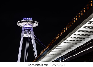 New Bridge over Danube River in Bratislava, Slovakia, at Night. Night view of the illuminated SNP bridge over Danube in Bratislava UFO..jpg