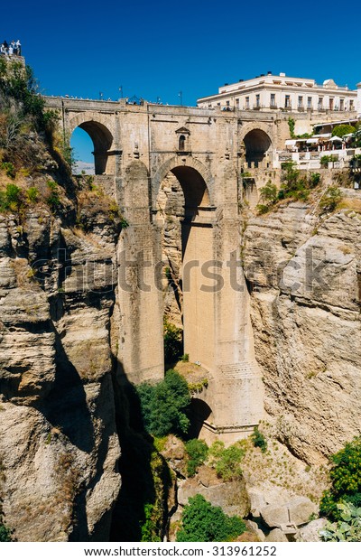 The New Bridge (Puente Nuevo) is the\
120-metre (390 ft)-deep chasm that carries the Guadalevin River and\
divides city of Ronda, Province Of Malaga,\
Spain