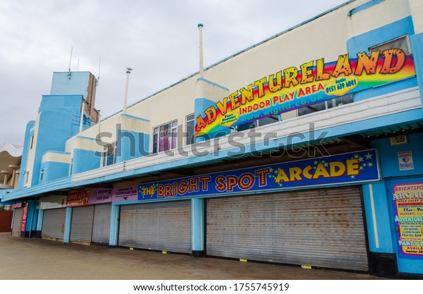 New Brighton, UK: Jun 3, 2020: A street view shows\
the impact of Corona virus pandemic on businesses which are\
required by law to close temporarily. Seaside amusement arcades\
would normally be open.