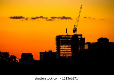 New Brunswick, New Jersey - June 14, 2018: Silhouette Of Crane Resting At Sunset Atop The New Brunswick Performing Arts Center Construction Site, The Newest Feature Of The Town’s Growing Skyline.