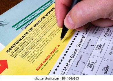 New Brunswick, NJ - October 28, 2020: Hand Prepares To Sign Signature On Official Mail-in Ballot For 2020 US General Election.