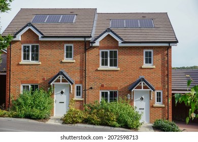 New build houses in England UK. Modern fresh new housing on a purpose build new housing estate. Solar panels on roof. 