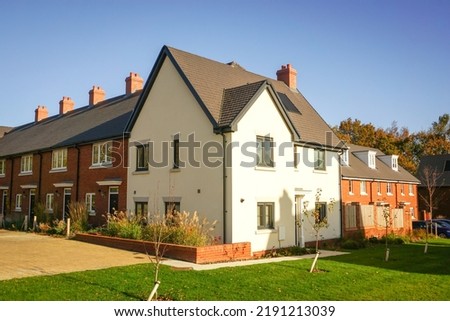 New build houses on new housing estate in England. Fresh newly built family homes. Housing and property market image