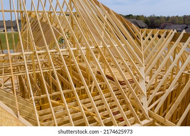 New build with wooden truss with timber trusses frame beam framework from an aerial view - Shutterstock ID 2174625973