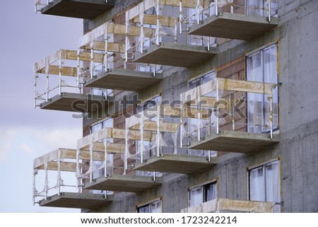 New building under construction and construction site of a residential building. the formation of cement supports in prefabricated forms. modern building under construction and scaffolding