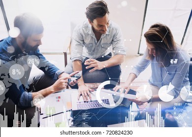 New business project startup.Group of young coworkers discussing ideas in modern office.Concept of digital diagram,graph interfaces,virtual screen,connections icon on blurred background.Top view