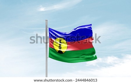New Caledonia national flag waving in the sky.