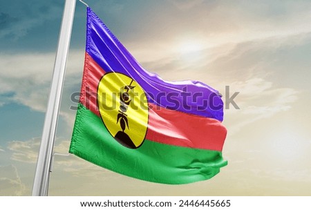 New Caledonia national flag waving in the sky.