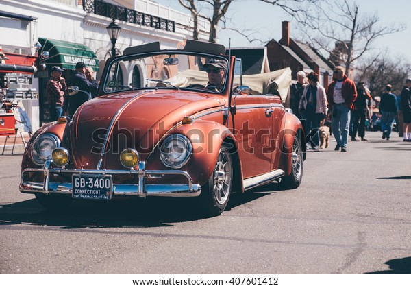 New Canaan,CT - April 17\
2016: At a free public car show in New Canaan, a classic VW Bug\
crawls away.