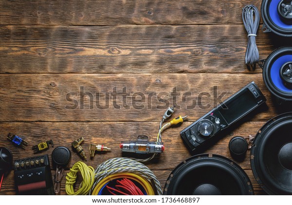 A new car audio equipment on brown wooden\
workbench background with copy\
space.