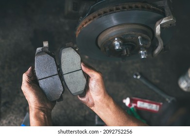 New car brake pads compared to old used brake pads. - Shutterstock ID 2092752256