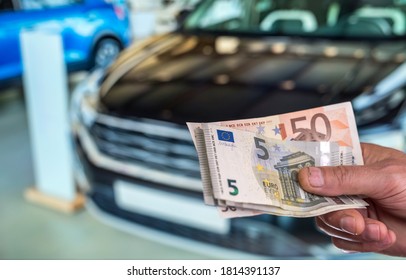 new car. buy or rent. hand holding euro banknotes. finance - Shutterstock ID 1814391137