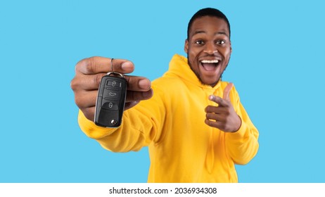 New Car. Excited Black Man Showing Key In Excitement Celebrating Buying New Auto Posing Standing On Blue Studio Background. Dreams Come True, Own Automobile Concept. Panorama, Selective Focus