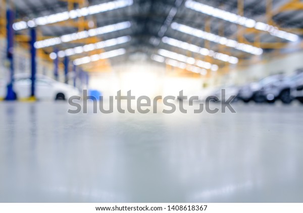 New car factory. epoxy floor in the car\
maintenance center Blurred background for the industry , epoxy\
floor in interior car-care\
center.