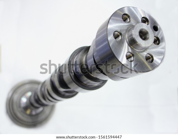 New car motor camshaft in perspective on white\
background close up