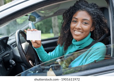 New car owner. Happy woman showing car license