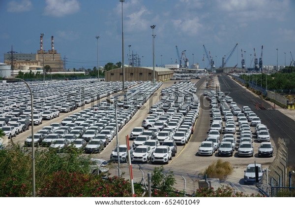 new\
car parking at the gate of the port before\
delivery