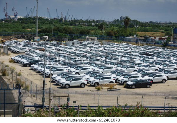 new car parking lot at the gate of the port\
before delivery