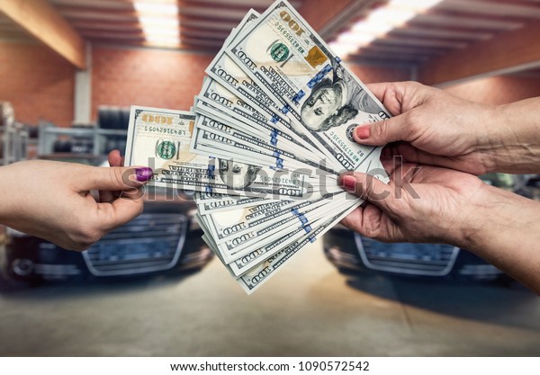 New car purchase,\
hands with dollar closeup