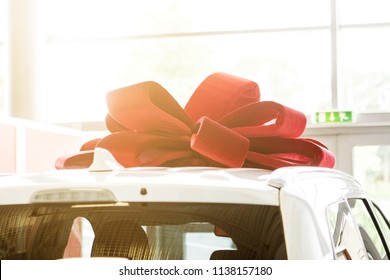 New Car With Red Bow As Present Concept