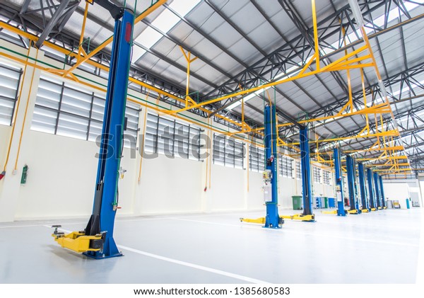A new car repair
service station Flooring with epoxy floor And there is an electric
lift for lifting cars that come to change the engine oil Electric
lift backdrop for car lift
